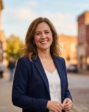 Sarah Hensley smiling on a small-town main street